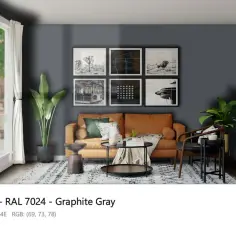 Nowoczesny salon w kolorze RAL 7024 jaki to kolor? Grafitowy, z pomarańczową kanapą i czarnymi ramkami na ścianie.